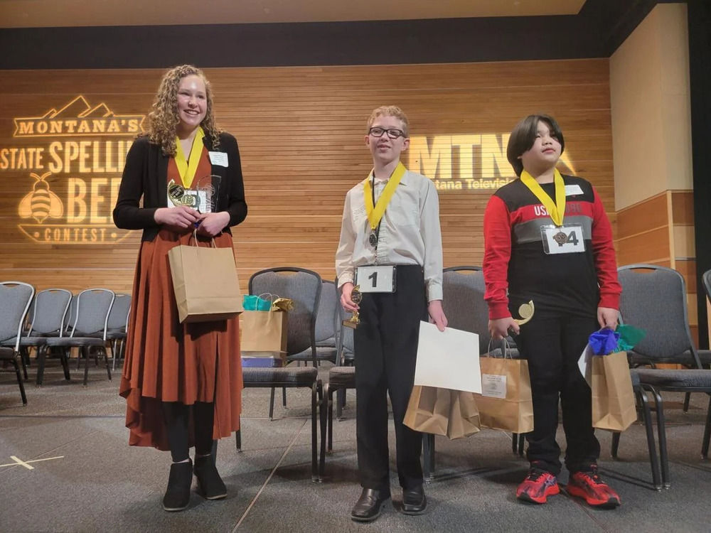 Jairo Tumonong of Roosevelt County, right, receives prize for winning third place at the 57th annual Treasure State Spelling Bee on Saturday, March 12, 2022